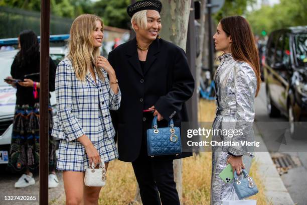 Bryan Boy wering blue Dior bag and Xenia Adonts is seen wearing checkered blazer and skirt, laced boots, micro bag Dior outside Dior on July 05, 2021...