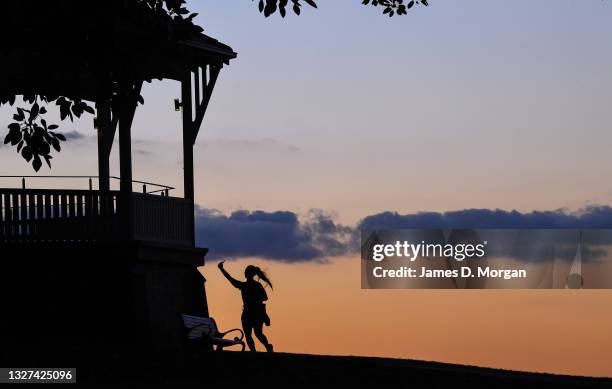 Woman takes a selfie on her mobile phone during sunset at Observatory Hill on July 07, 2021 in Sydney, Australia. Lockdown restrictions have been...