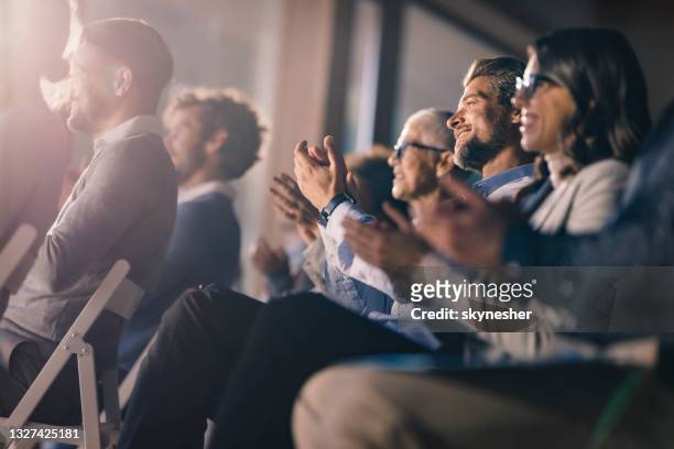large group of happy entrepreneurs applauding on a seminar in board room. - applauding stock pictures, royalty-free photos & images
