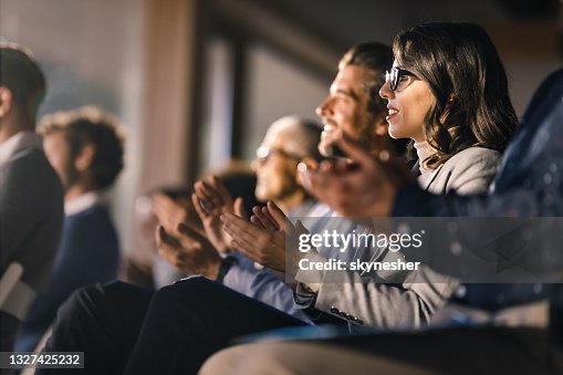 Glückliche Geschäftsfrau und ihre Kollegen applaudieren bei einer Bildungsveranstaltung im Sitzungssaal. Glückliche Geschäftsfrau und ihre Kollegen applaudieren bei einer Bildungsveranstaltung im Sitzungssaal.