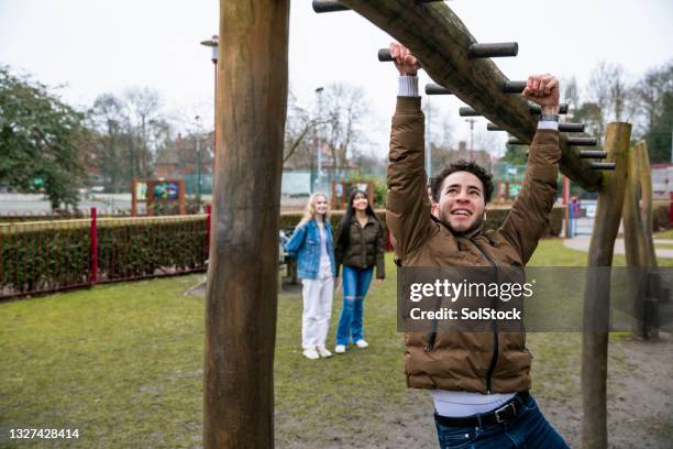 showing them how to do it - climbing frame stock pictures, royalty-free photos & images