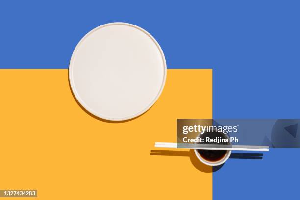 abstract photography with empty plate, chopsticks and soy sauce in trendy color block style. top view. flat lay. - blue plate stock pictures, royalty-free photos & images