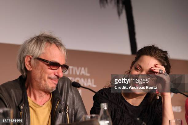 Director Leos Carax and Marion Cotillard attend the "Annette" press conference during the 74th annual Cannes Film Festival on July 07, 2021 in...