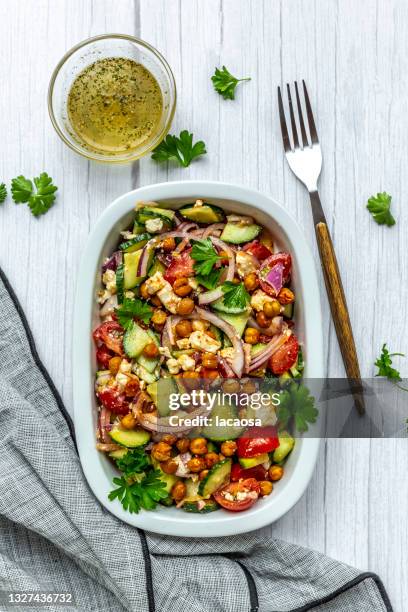 bowl of vegetarian salad with chick-peas, cucumber, tomatoes, feta and onion - mediterranean food ストックフォトと画像