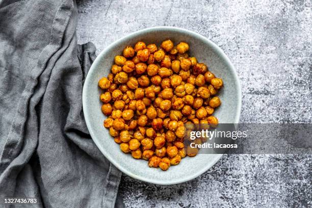 bowl with roasted chick peas - crunchy snacks stock pictures, royalty-free photos & images