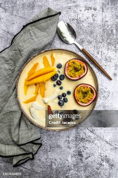 smoothie bowl with mango, coconut, passion fruit and blueberries - passion fruit imagens e fotografias de stock