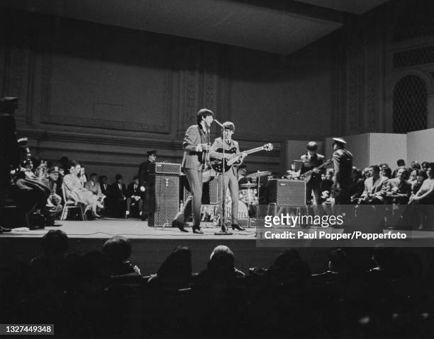 English pop group The Beatles perform live on stage at Carnegie Hall in New York during the band's first visit to the United States on 12th February...