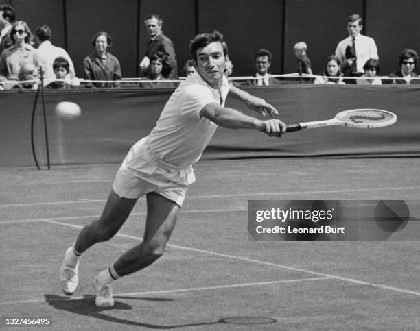 Stanley Matthews of Great Britain reaches to make a backhand return against Cliff Drysdale of South Africa during their Men's Singles First Round...