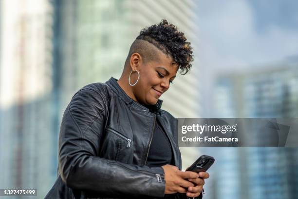 smiling african american woman in the city - jamaicansk stock pictures, royalty-free photos & images