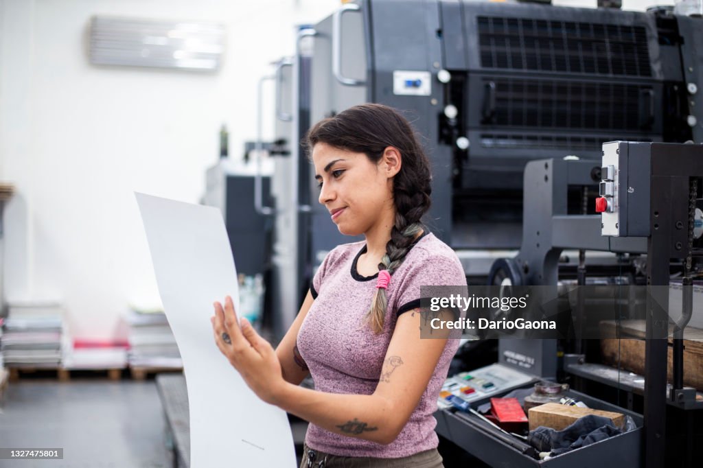 Young woman working in a printing press
