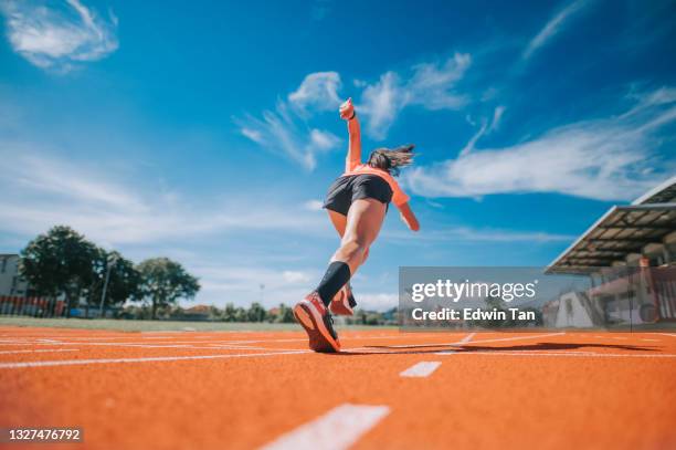 rear view aerodynamic asian chinese female athletes sprint running at track and run towards finishing line in the morning at track and field stadium - pursuit sports competition format stock pictures, royalty-free photos & images