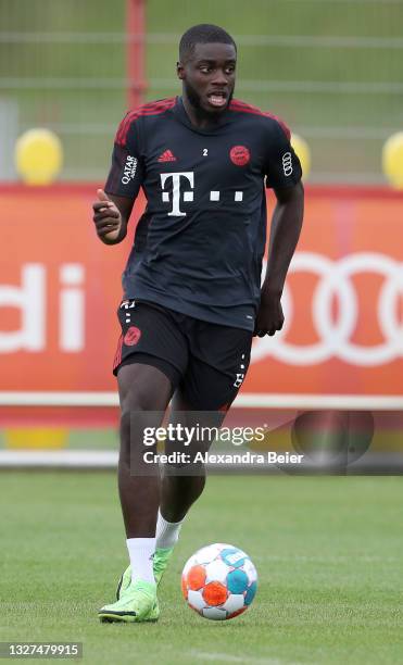 New player Dayot Upamecano of FC Bayern Muenchen kicks the ball during his first training session of the upcoming season 2021/2022 on July 07, 2021...