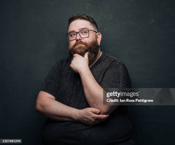 bearded hipster man deep in thought - chubby men stock pictures, royalty-free photos & images