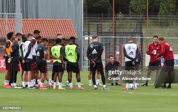 New team coach Julian Nagelsmann of FC Bayern Muenchen shows a board to his players during the first training session of the upcoming season...