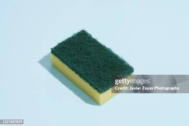 scouring pad on blue background - scourer stock pictures, royalty-free photos & images