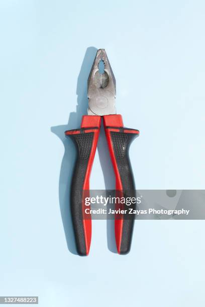 pliers on blue background - pliers stockfoto's en -beelden