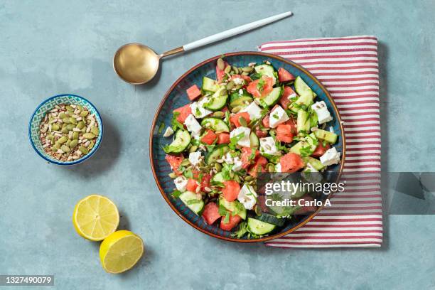 watermelon  goat cheese and cucumber salad - cucumber leaves stock-fotos und bilder