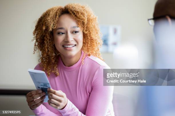young woman discusses her care and treatment plan with a compassionate doctor - doctor publication stock pictures, royalty-free photos & images