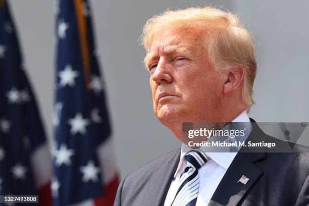 Former U.S. President Donald Trump looks on during a press conference announcing a class action lawsuit against big tech companies at the Trump...