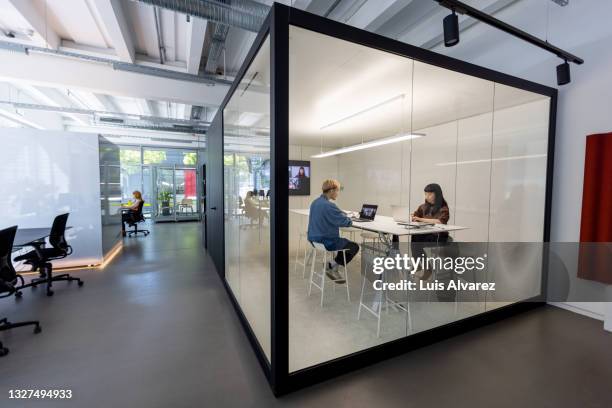 businesspeople working inside hybrid office cubicle - office cubicle stock-fotos und bilder