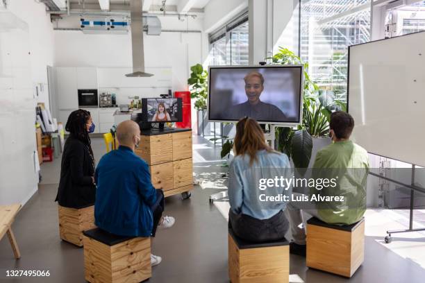 entrepreneur doing video call with colleagues - テレビ　会議 ストックフォトと画像