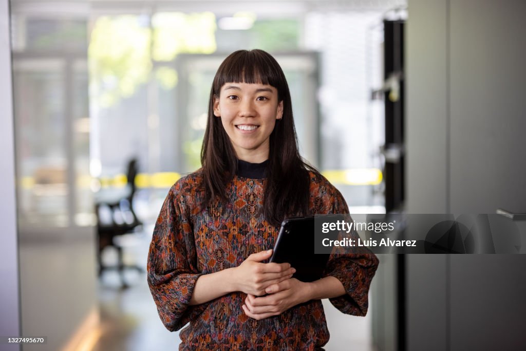 Asian businesswoman standing in hybrid office