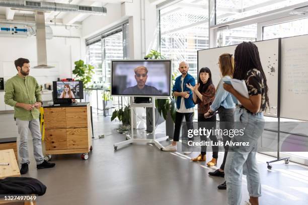 group of people having a meeting in hybrid workplace - employee engagement remote stock pictures, royalty-free photos & images