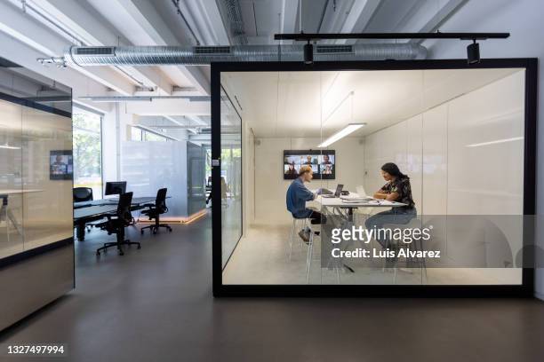 business people working in hybrid office space - office stock-fotos und bilder