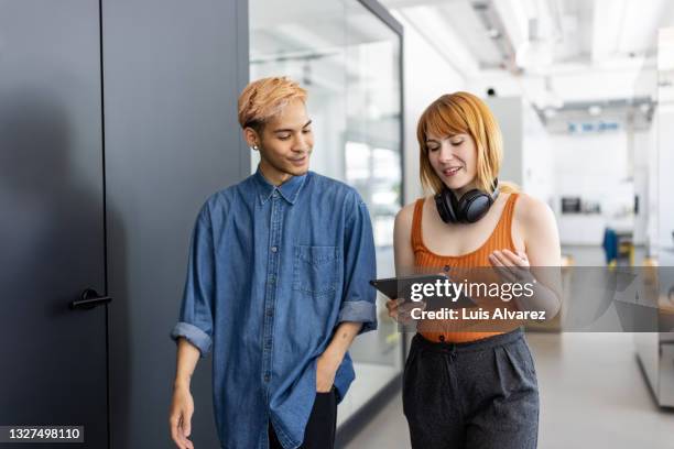 startup business partners walking and talking in office - creative collaboration holding stockfoto's en -beelden