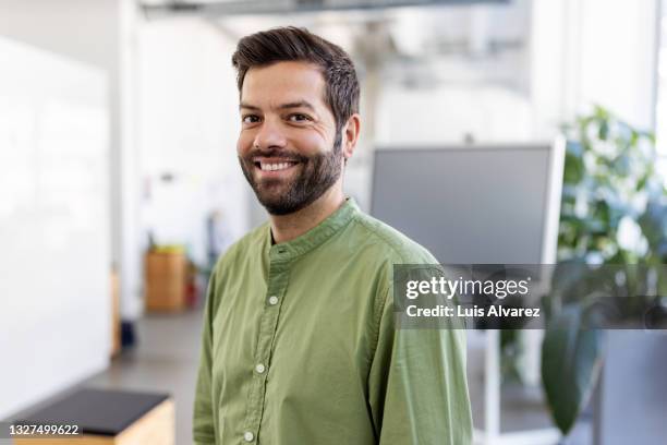 close-up of a male business professional in office - employee headshot stock pictures, royalty-free photos & images