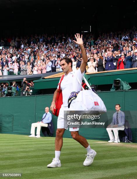 Roger Federer of Switzerland waves to the crowd after losing his men's Singles Quarter Final match against Hubert Hurkacz of Poland on Day Nine of...