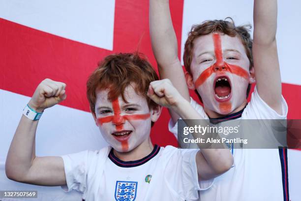 Young England fans wearing face paint show their support outside the stadium prior to the UEFA Euro 2020 Championship Semi-final match between...