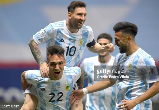 Lautaro Martinez of Argentina celebrates with teammates Lionel Messi and Nicolás Gonzalez after scoring the first goal of his team during a...