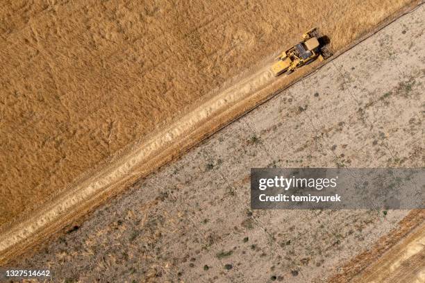 harvesting a wheat field - extreme weather farm stock pictures, royalty-free photos & images