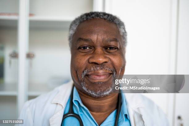 close up portrait of smiling doctor - handsome doctors stock pictures, royalty-free photos & images