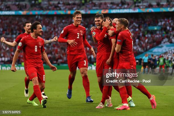 Mikkel Damsgaard of Denmark celebrates with Thomas Delaney, Jannik Vestergaard, Andreas Christensen and Jens Stryger Larsen after scoring their...