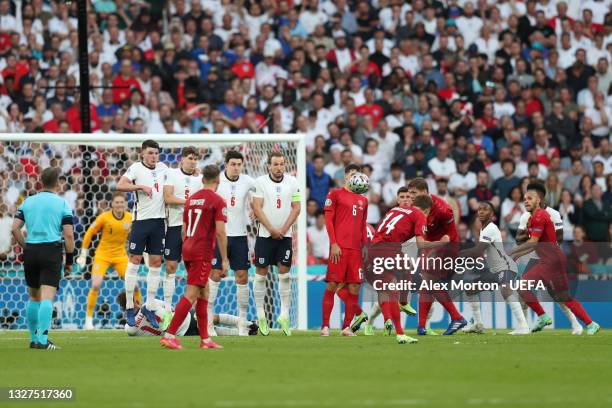 Mikkel Damsgaard of Denmark scores their side's first goal during the UEFA Euro 2020 Championship Semi-final match between England and Denmark at...