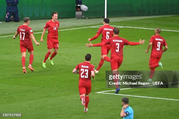 Mikkel Damsgaard of Denmark celebrates with teammates after scoring their side's first goal during the UEFA Euro 2020 Championship Semi-final match...