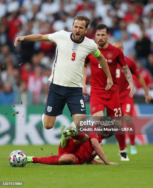 Harry Kane of England is challenged by Thomas Delaney of Denmark during the UEFA Euro 2020 Championship Semi-final match between England and Denmark...