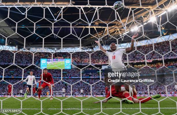 Simon Kjaer of Denmark scores an own goal, England's first goal, whilst under pressure from Raheem Sterling of England during the UEFA Euro 2020...