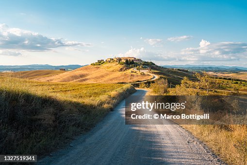 Country road to hilltop village, Tuscany, Italy Country road to hilltop village, Tuscany, Italy