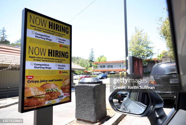 Now Hiring" sign is posted in the drive thru of a McDonald's restaurant on July 07, 2021 in San Rafael, California. As the economy continues to...