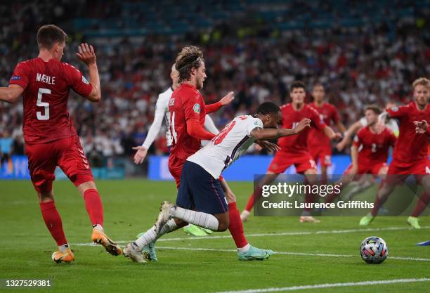 Raheem Sterling of England is fouled by Mathias Jensen of Denmark inside the penalty area, leading to England being awarded a penalty during the UEFA...