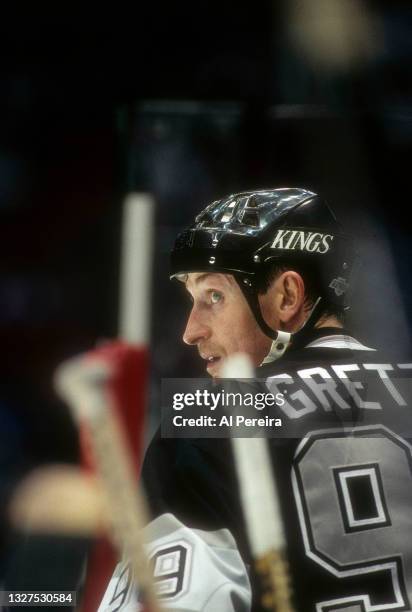 Wayne Gretzky of the Los Angeles Kings follows the action from the bench in the game between the Los Angeles Kings vs The New Jersey Devils at the...