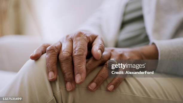 of a senior woman's hands while sitting at home - widow pension stock pictures, royalty-free photos & images