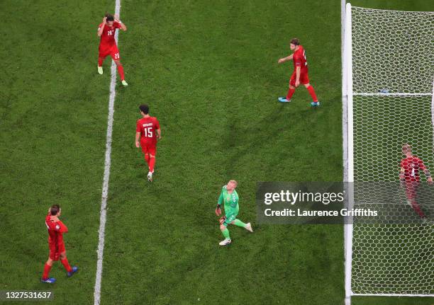 Jannik Vestergaard, Yussuf Poulsen, Christian Norgaard, Kasper Schmeichel, Joachim Andersen and Simon Kjaer of Denmark look dejected after conceding...