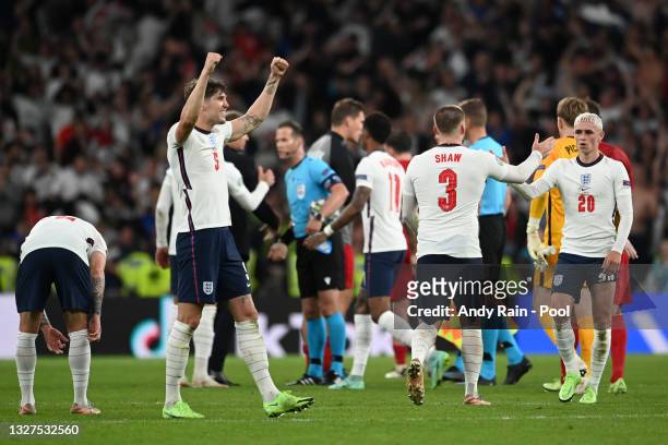 John Stones, Luke Shaw and Phil Foden of England celebrate following their team's victory in the UEFA Euro 2020 Championship Semi-final match between...