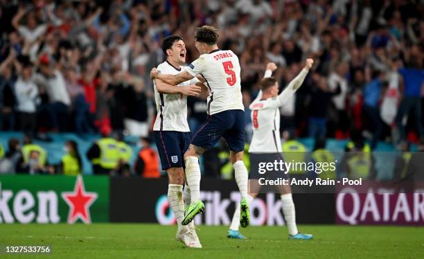 Harry Maguire and John Stones of England celebrate following their team's victory in the UEFA Euro 2020 Championship Semi-final match between England...