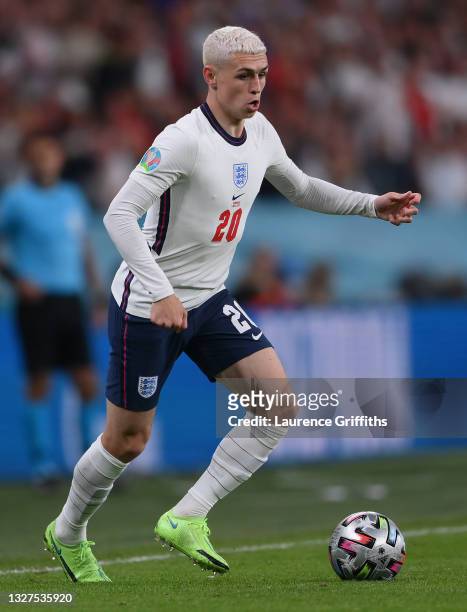 Phil Foden of England runs with the ball during the UEFA Euro 2020 Championship Semi-final match between England and Denmark at Wembley Stadium on...