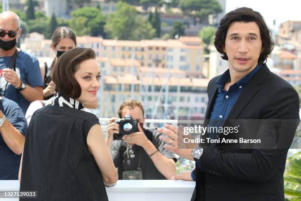 Marion Cotillard and Adam Driver attend the "Annette" photocall during the 74th annual Cannes Film Festival on July 06, 2021 in Cannes, France.